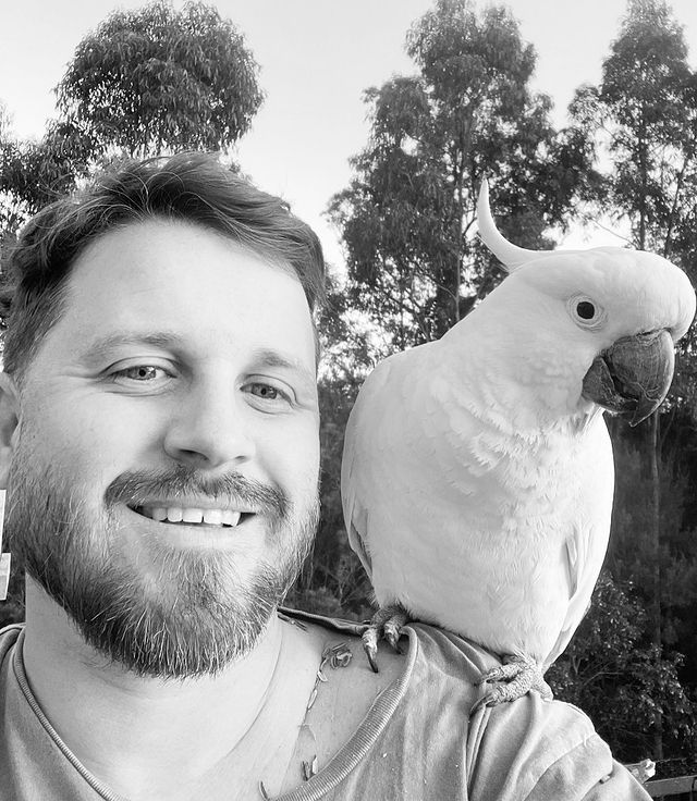 Mike Handcock with a parrot on his shoulder